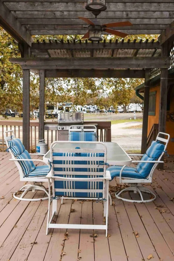 The shaded lakeside pavilion with its pergola, table and chairs